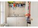 This utility room features a washer, dryer, and storage shelves above the appliances at 103 Avalon Ct, Goose Creek, SC 29445