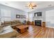 Spacious living room with a fireplace, wood-look flooring, a sectional couch, and ample natural light at 103 Avalon Ct, Goose Creek, SC 29445