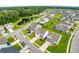 Aerial view of a residential community featuring well-maintained homes, a pond, and mature trees at 107 Goose Rd, Summerville, SC 29483