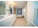 Bright and spacious bathroom featuring double sinks, a large tub, and a separate shower at 107 Goose Rd, Summerville, SC 29483