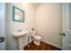 Stylish half-bathroom with a modern vanity, toilet, and wood-look vinyl flooring at 107 Goose Rd, Summerville, SC 29483