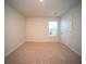 Bright bedroom featuring neutral carpeting, a window, and doorway at 107 Goose Rd, Summerville, SC 29483