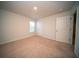 Bright bedroom featuring neutral carpeting, a window, and doorway at 107 Goose Rd, Summerville, SC 29483