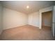 A spacious bedroom with neutral carpet, light walls, and a doorway to an adjacent space at 107 Goose Rd, Summerville, SC 29483