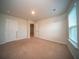 Bright bedroom with neutral carpet, light walls, with multiple doorways and a sun-filled window at 107 Goose Rd, Summerville, SC 29483