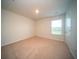 Bright bedroom featuring neutral carpeting, a window, and doorway at 107 Goose Rd, Summerville, SC 29483