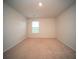 This bright bedroom features neutral carpet, light walls, and a window bringing in natural light at 107 Goose Rd, Summerville, SC 29483