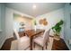 Bright dining room features wood floors, and a wooden table with six chairs and decorative accents at 107 Goose Rd, Summerville, SC 29483