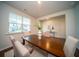 Bright dining room showcasing wood floors, table, six chairs, and natural light from the window at 107 Goose Rd, Summerville, SC 29483