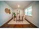 Bright dining area featuring a wooden table set with neutral upholstered chairs, enhanced by stylish decor and natural light at 107 Goose Rd, Summerville, SC 29483