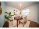Well-lit dining area featuring a wooden table set with neutral upholstered chairs, enhanced by stylish decor and natural light at 107 Goose Rd, Summerville, SC 29483