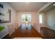 Clean dining room with wood floors, table, six chairs, and ample natural light through a window at 107 Goose Rd, Summerville, SC 29483