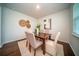 Cozy dining area featuring a wooden table set with neutral upholstered chairs, enhanced by stylish decor and natural light at 107 Goose Rd, Summerville, SC 29483