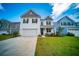 Charming two-story home featuring a well-manicured lawn and a classic white exterior, perfect for suburban living at 107 Goose Rd, Summerville, SC 29483
