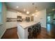 Spacious kitchen featuring granite counters, stainless appliances, island seating, and ample lighting at 107 Goose Rd, Summerville, SC 29483
