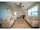 Cozy living room with a fireplace, ceiling fan and neutral furniture at 107 Goose Rd, Summerville, SC 29483