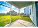 Screened-in patio overlooking a well-manicured lawn, perfect for outdoor relaxation and entertaining at 107 Goose Rd, Summerville, SC 29483