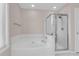 Bright bathroom features a soaking tub with jets and a glass-enclosed shower stall at 1127 Tidal View Ln, Charleston, SC 29412