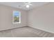 A bright bedroom featuring neutral walls, carpet, and a window with blinds, creating a cozy and inviting space at 1127 Tidal View Ln, Charleston, SC 29412