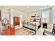 Bright bedroom features a wrought iron bed, rug and furniture at 114 E Respite Ln, Summerville, SC 29483