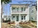 Charming two-story home with a double-porch, light blue siding, and landscaped front yard at 114 E Respite Ln, Summerville, SC 29483