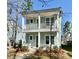 Charming two-story home with a double-porch, light blue siding, and landscaped front yard at 114 E Respite Ln, Summerville, SC 29483