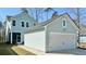 Exterior view of the home with a detached garage, covered patio, and light blue siding at 114 E Respite Ln, Summerville, SC 29483