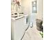 Clean laundry room with new washer and dryer, modern storage, and sleek flooring at 114 E Respite Ln, Summerville, SC 29483