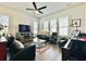 Comfortable living room with plentiful natural light, featuring leather seating and entertainment center at 114 E Respite Ln, Summerville, SC 29483