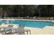 Community pool with lounge chairs and tables for relaxing poolside at 114 E Respite Ln, Summerville, SC 29483