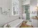 Bright bathroom featuring a clawfoot tub and glass shower at 115 Rutledge Ave # A, Charleston, SC 29401