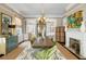 Elegant dining room with large table, chandelier, and fireplace at 115 Rutledge Ave # A, Charleston, SC 29401