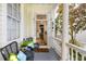 Inviting porch with seating and an open doorway revealing the home's interior at 115 Rutledge Ave # A, Charleston, SC 29401