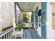 Inviting screened-in porch featuring colorful decor, shutters, and a striped rug at 115 Rutledge Ave # A, Charleston, SC 29401