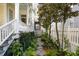 Landscaped side yard with a stone path, white picket fence, and lush plants at 115 Rutledge Ave # A, Charleston, SC 29401