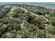 An aerial shot showcasing a lake surrounded by trees, homes, and a golf course at 12 Dune Crest Trace Trl, Seabrook Island, SC 29455