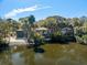 Aerial view of waterfront houses surrounded by lush trees and clear skies at 12 Dune Crest Trace Trl, Seabrook Island, SC 29455