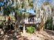 Charming elevated exterior featuring wooden deck, stairs and mature trees at 12 Dune Crest Trace Trl, Seabrook Island, SC 29455