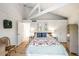 Bright bedroom with wooden floors, white ceiling beams, and floral bedding at 12 Dune Crest Trace Trl, Seabrook Island, SC 29455