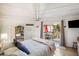 Bedroom with a deck view, a bookshelf, and light streaming through open doors at 12 Dune Crest Trace Trl, Seabrook Island, SC 29455