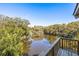 Balcony view of a pond surrounded by green trees on a sunny day at 12 Dune Crest Trace Trl, Seabrook Island, SC 29455