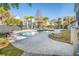 Beautiful pool area with stone pavers, palm trees, and lounge chairs at 122 Lucia St, Charleston, SC 29492