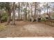 The backyard features tall, mature trees, providing shade and privacy to enjoy outdoor living at 122 Moon Shadow Ln, Summerville, SC 29485