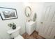 Charming half bath with tile floors, modern fixtures, oval mirror, and tasteful décor at 122 Moon Shadow Ln, Summerville, SC 29485