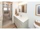 Upstairs bathroom features a gray vanity, framed mirror, decorative basket, and natural light at 122 Moon Shadow Ln, Summerville, SC 29485