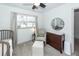 Bedroom boasts a chair, crib, window, and changing table, offering a serene and inviting space at 122 Moon Shadow Ln, Summerville, SC 29485