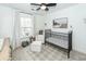 A sweet Bedroom that has lots of natural light and is furnished with a crib and comfy chair at 122 Moon Shadow Ln, Summerville, SC 29485