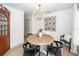 Elegant dining area features a wood table, black chairs, and modern brass chandelier at 122 Moon Shadow Ln, Summerville, SC 29485
