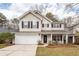 Charming two-story home with attached garage, black shutters, and welcoming front porch at 122 Moon Shadow Ln, Summerville, SC 29485
