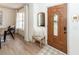 Cozy foyer with hardwood floors, a decorative mirror, and a beautifully crafted wooden front door at 122 Moon Shadow Ln, Summerville, SC 29485